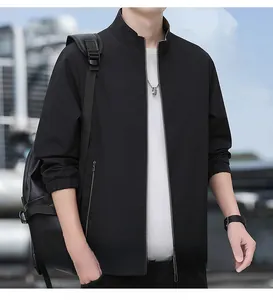 Detail of black standing collar jacket with smooth texture and elastic ribbed cuffs