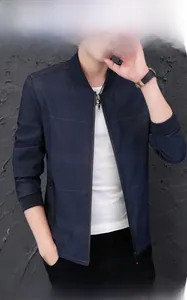 Detailed view of the dark blue ribbed stand collar and zip closure on men jacket