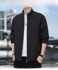 Detailed outdoor shot of a men's black stand-collar business jacket with ribbed cuffs