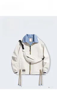 Detail of white outdoor jacket with blue collar lining and adjustable metal drawstring