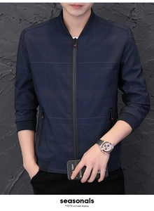 Detail of navy blue plaid jacket showing ribbed cuffs and zippered pockets on a male model