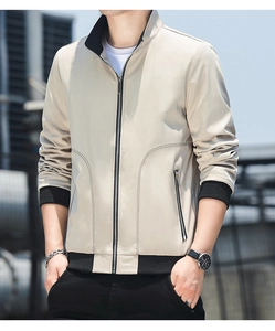 Close-up of the beige jacket featuring black ribbed collar and smooth metal zipper details