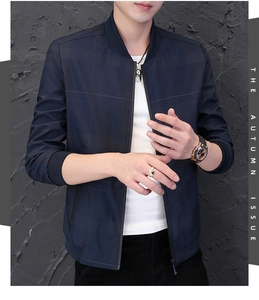 Detail of navy blue men's stand collar jacket with subtle textured grid pattern