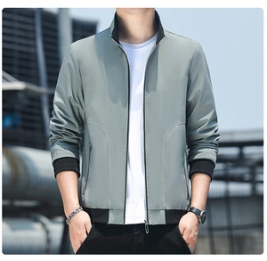 Detail of light green men's stand collar jacket with black ribbed cuffs and zipper pockets