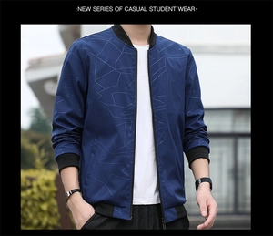 Detail of navy blue bomber jacket showing geometric pattern and ribbed cuffs and hem