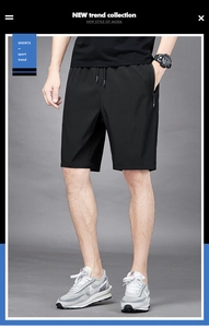 Detail view of quick-dry black sports shorts featuring elastic waistband and zipper pocket