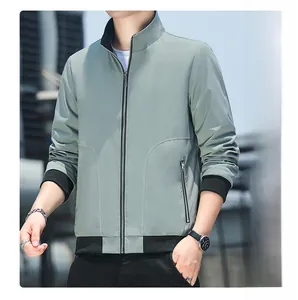 Detail of light green men's jacket showing zipper pocket and black ribbed cuff textures