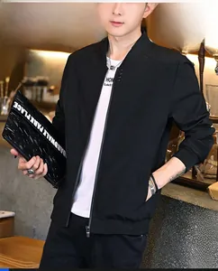 Detail of men's black varsity jacket featuring ribbed cuffs and stand collar