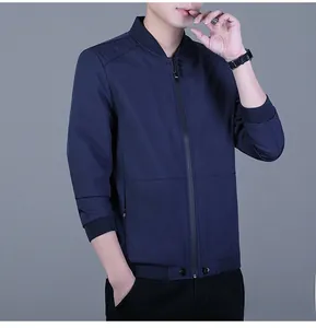 Detail of navy blue lightweight jacket featuring ribbed cuffs and classic baseball collar