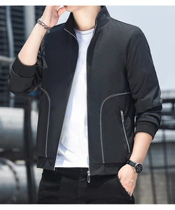 Detail of black stand collar jacket featuring white decorative lines and metal zipper pockets