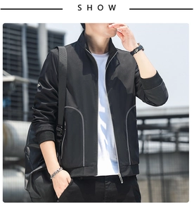Detail view of black stand collar jacket featuring contrasting white stitching and ribbed cuffs