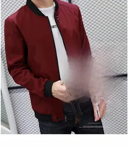 Detail of burgundy bomber jacket with black ribbed collar and zipper closure