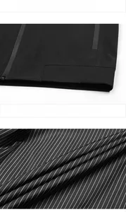 Detailed macro view of dark men's jacket featuring ribbed cuffs and striped inner lining