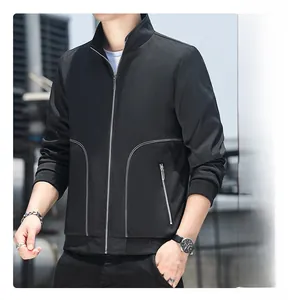 Detail of black stand-collar jacket featuring white geometric piping and side zipper pocket