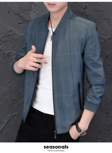 Detailed close-up of men's dark grey-blue bomber jacket with subtle plaid pattern