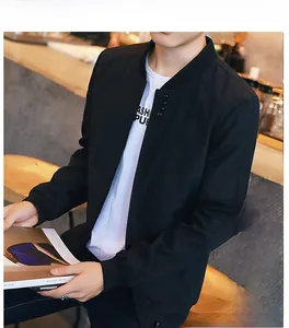 Detail of men's black bomber jacket featuring a four-button collar and adjustable hem cord