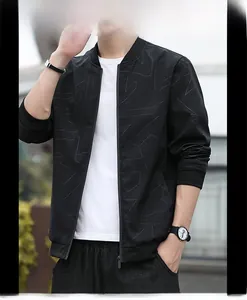 Detail of men's slim fit black bomber jacket featuring grey geometric line patterns