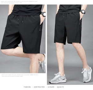 Detail of men's quick-dry sports shorts featuring drawstring waist and secure zipper pocket