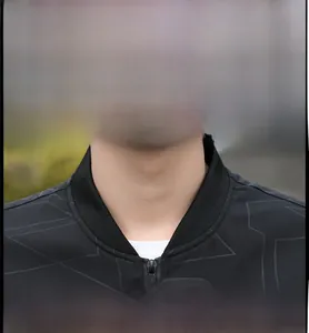 Detail of black men's jacket featuring a ribbed baseball collar and geometric patterns