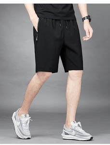 Detail of men's quick-dry sports shorts featuring elastic drawstring waist and zipper pocket