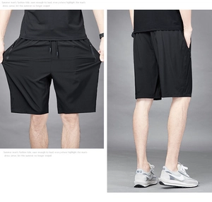 Detail of high-stretch quick-dry fabric and side zipper pocket on men's sports shorts