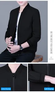 Detail view of the stand-up collar with decorative buttons and ribbed cuffs on black jacket