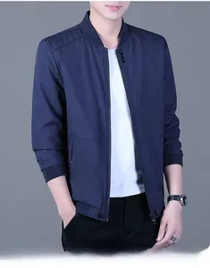 Detail of navy blue windbreaker jacket with ribbed stand collar and front zipper