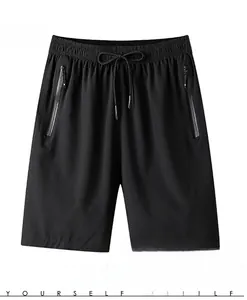 Detail of men's quick-dry black sports shorts featuring elastic drawstring and zipper pockets