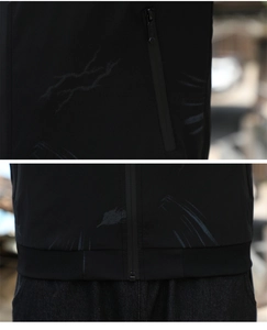 Detail of black jacket showing vertical zip pocket, rib-knit hem, and abstract print