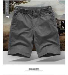 Detail view of dark gray cotton cargo shorts featuring elastic waist and button closure