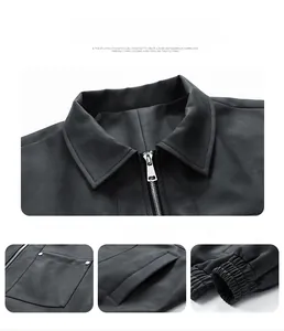 Detail view of leather biker jacket with silver zippers, chest pockets and elastic cuffs