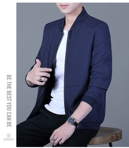 Close-up of navy blue bomber jacket with stand collar and decorative button detail
