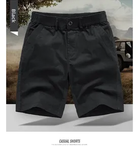 Detail of men's black cotton cargo shorts featuring drawstring waist and side pockets
