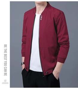 Detail of burgundy slim fit jacket showing metallic buttons and windproof ribbed cuffs