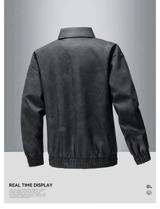 Detail view of the back of a charcoal gray faux leather jacket with ribbed cuffs