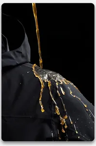 Macro shot of black jacket showing waterproof leaf effect and liquid repellent technology