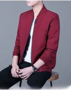 Detail view of the deep red windbreaker jacket showing the collar with black buttons