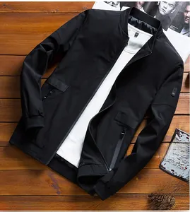Detailed view of black men's bomber jacket with sleeve patch and ribbed hem detail