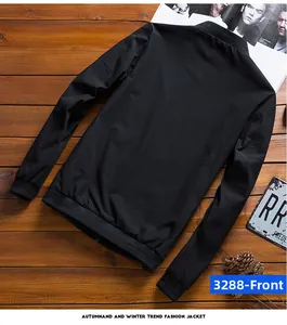 Detail of black bomber jacket featuring ribbed collar and windproof polyester fabric texture