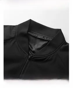 Detailed view of the ribbed baseball collar and metal zipper on black casual jacket