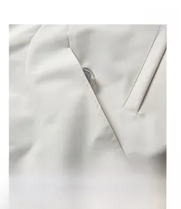 Detailed close-up of side pocket stitching on an off-white casual American baseball jacket