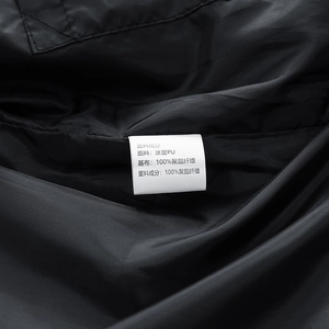 Close-up of the wash care label showing fabric composition on a black leather jacket