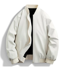 Detailed close-up of cream bomber jacket featuring black lining and ribbed knit collar