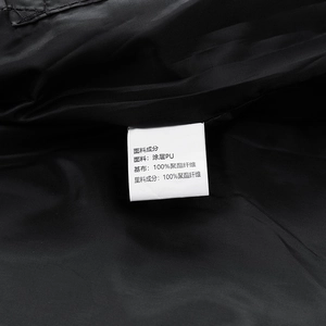Close-up of men's PU leather jacket care label showing 100% polyester lining material