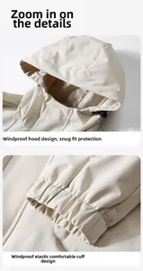 Detail of adjustable windproof hood and elastic cuffs on a beige tactical outdoor jacket