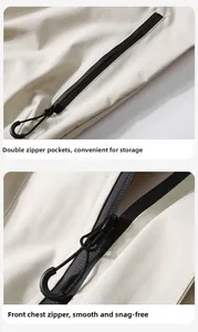 Detail view of cream hiking jacket with black waterproof zippers and seam sealing