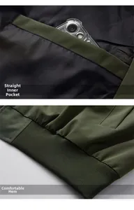 Detail showing the deep inner pocket and elastic ribbed hem of the military green jacket