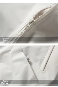 Detail of smooth metal zipper closure and side pocket on beige casual baseball jacket