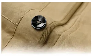 Macro shot of high-gloss resin button on a khaki twill cotton jacket with neat stitching