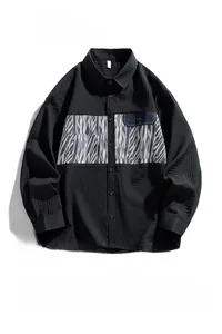 Detailed close-up of men's long sleeve corduroy shirt with vintage geometric pattern patchwork